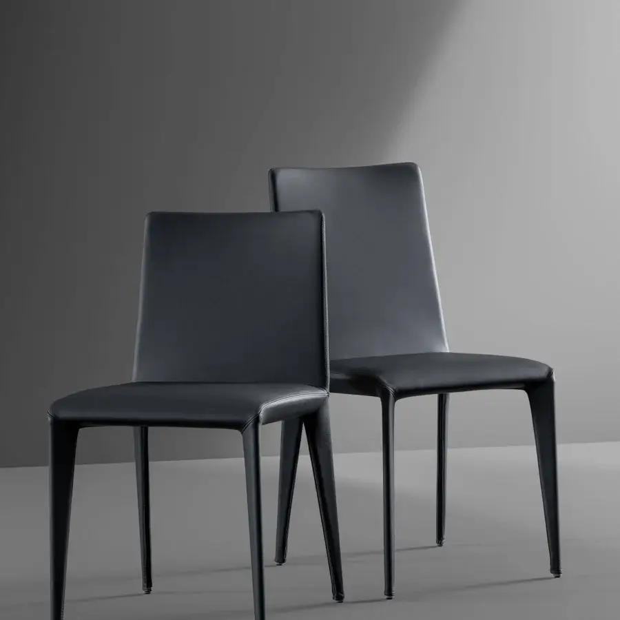 Distinguished Bonaldo Filly chair upholstered in dark fabric or leather with slender metal legs and a gently curved backrest