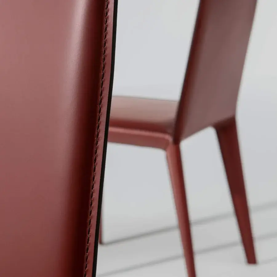 Distinguished Bonaldo Filly chair crafted in reddish-brown leather with smooth finish and matching matte metal legs
