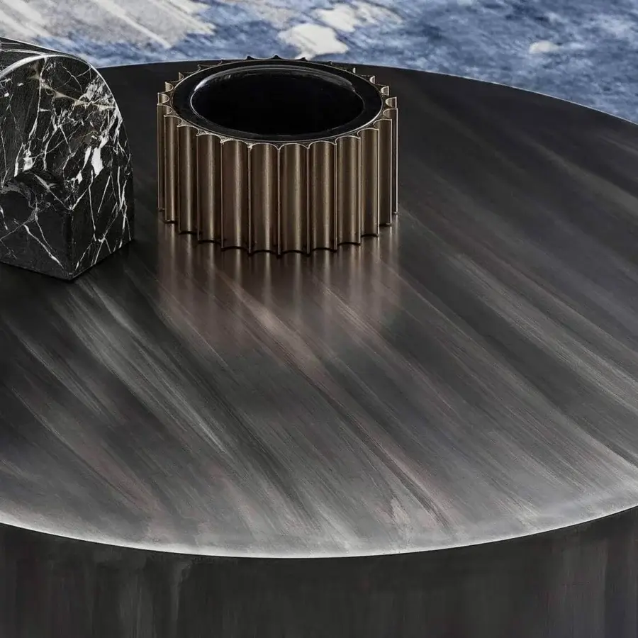 Distinguished Rugiano Genesi side table in flamed iron with linear striations and glossy gold details exhibiting a dark matte finish