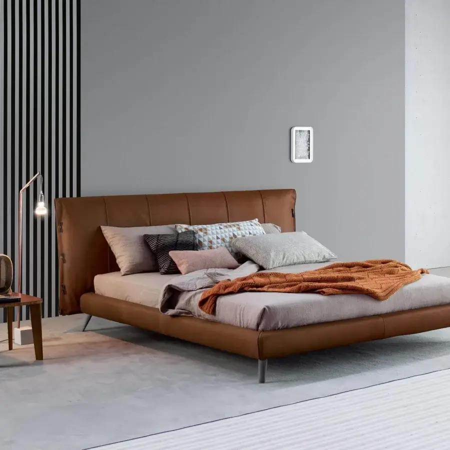 Distinguished Bonaldo Cuff bed with smooth matte brown leather upholstery and refined stitching detailing on a low frame