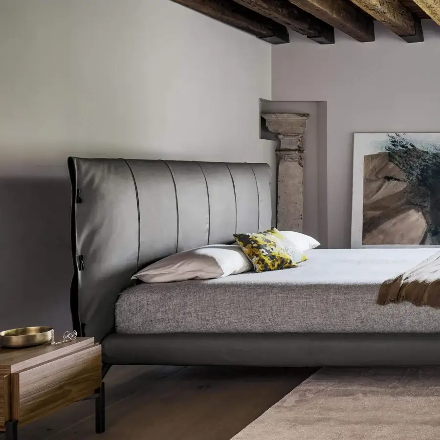 Elegant Bonaldo Cuff bed with textured light gray fabric upholstery and vertical stitched headboard details