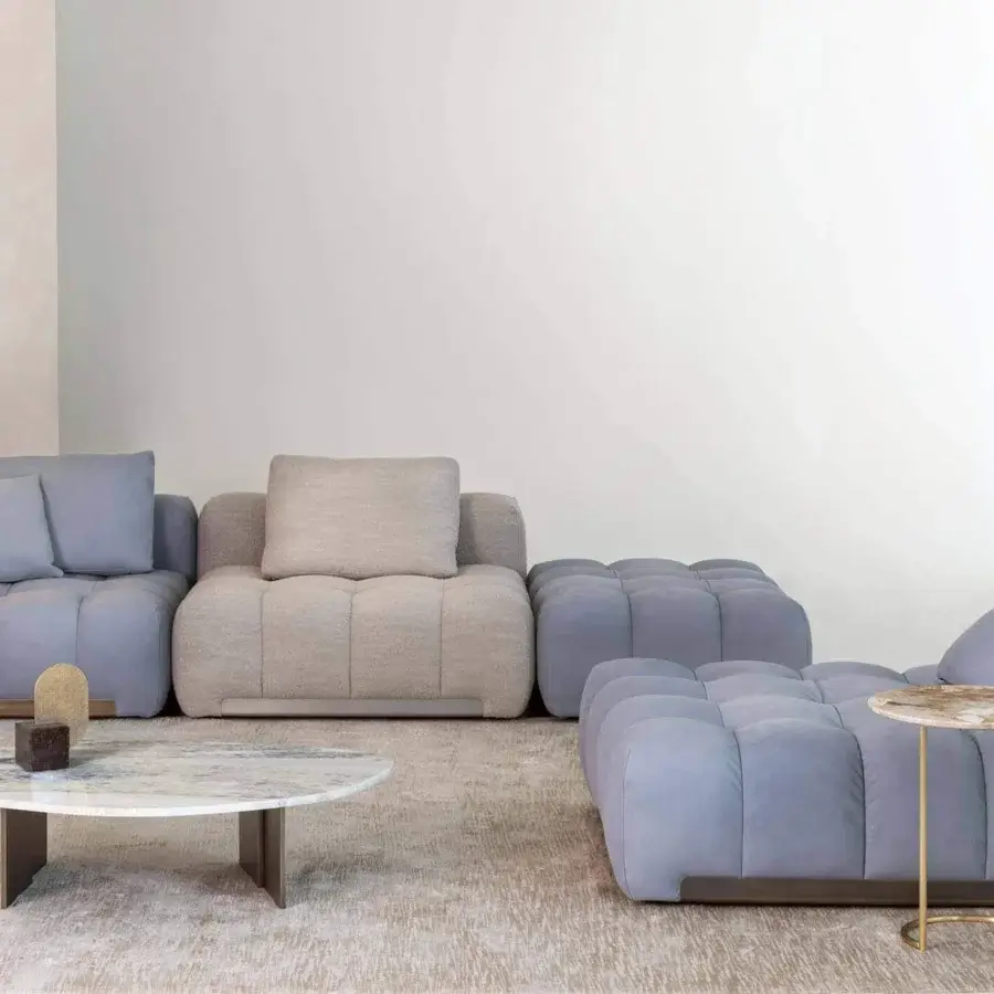 Distinguished Rugiano Yacht sectional with light blue-gray textile upholstery and quilted padded sections crafted with a smooth wood base and bronze brass details