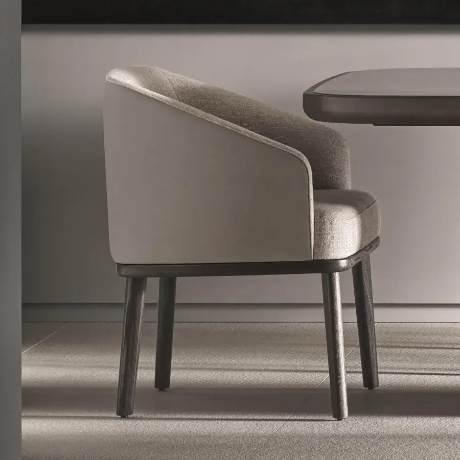 Refined Ditre Italia St. Tropez armchair with muted gray-beige fabric and curved wood-like frame showcasing a matte finish