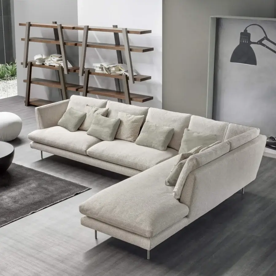 Superior Bonaldo Lars sectional with light beige textile upholstery and slender metal feet, complemented by sage throw pillows