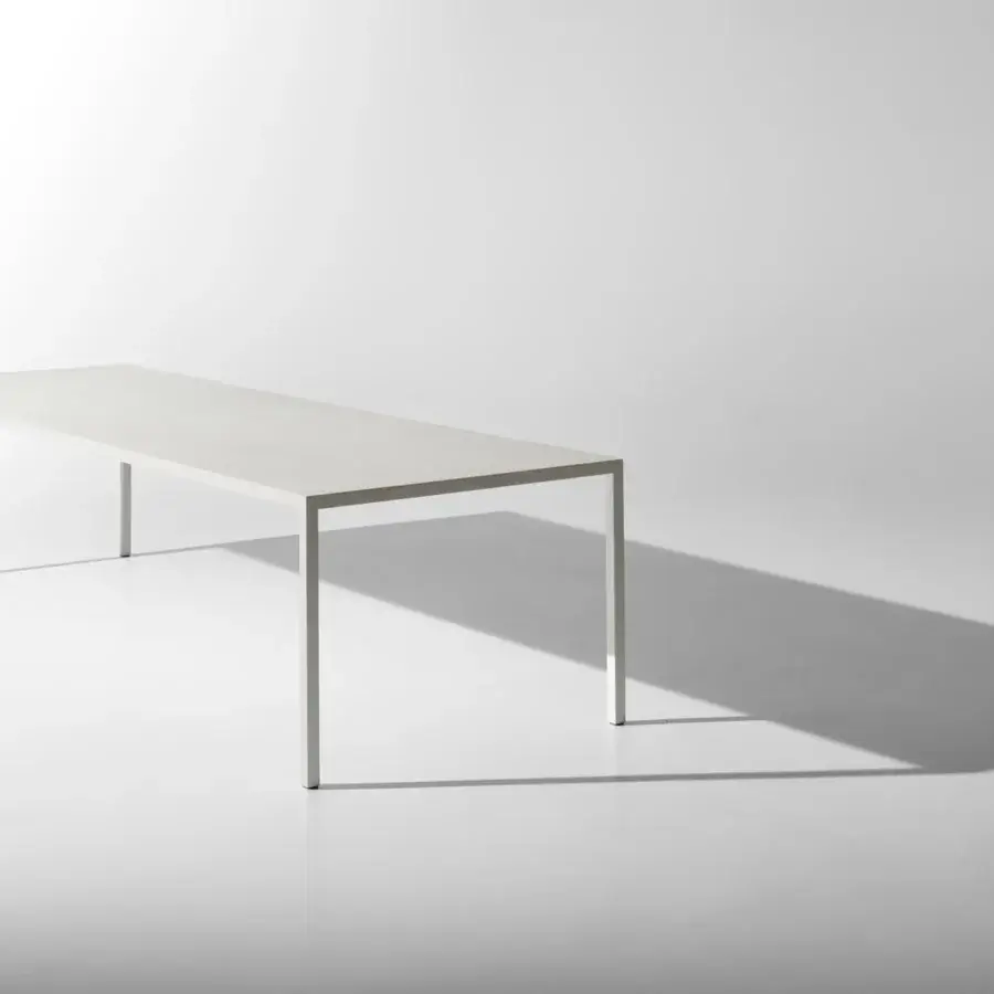 Elegant MDF Italia Tense Material table with clean lines and matte white finish built with composite board and slender steel legs