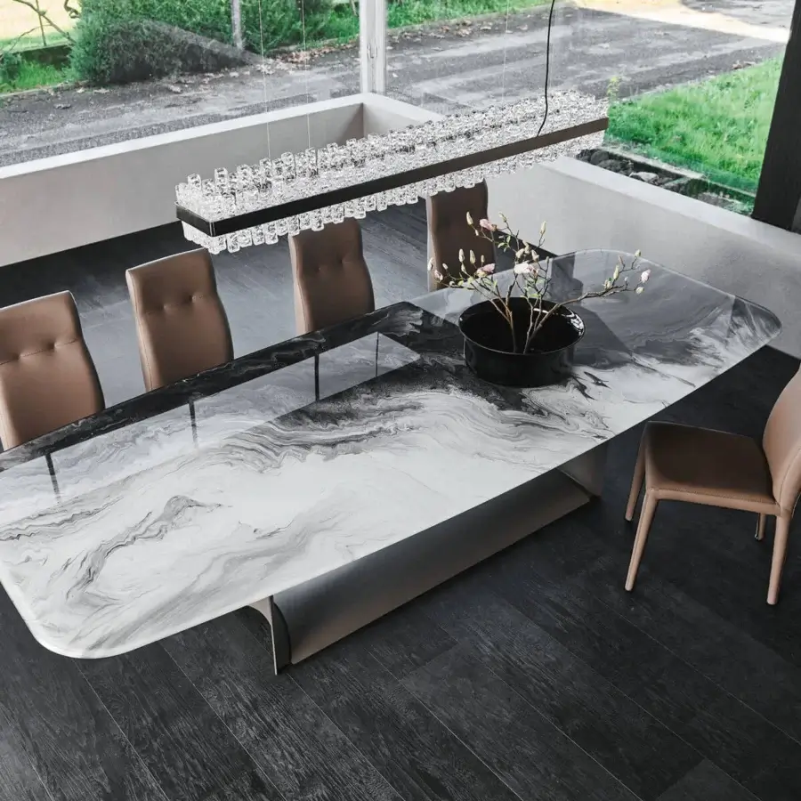 Distinguished Cattelan Italia Dragon table with black embossed steel and extra clear beveled glass exhibiting a marbled glossy finish