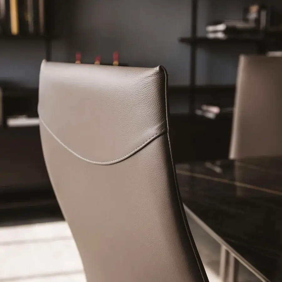 Distinguished Cattelan Italia Norma chair with sleek curved silhouette and muted taupe synthetic leather upholstery built with a steel frame