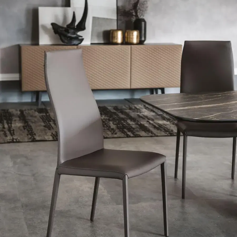 Elegant Cattelan Italia Norma chair in medium gray-brown synthetic leather with a sleek curved backrest and slender legs