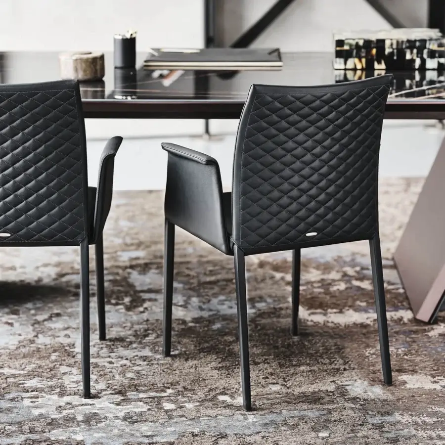 Captivating Cattelan Italia Norma chair in dark synthetic leather with quilted seatback and black steel frame