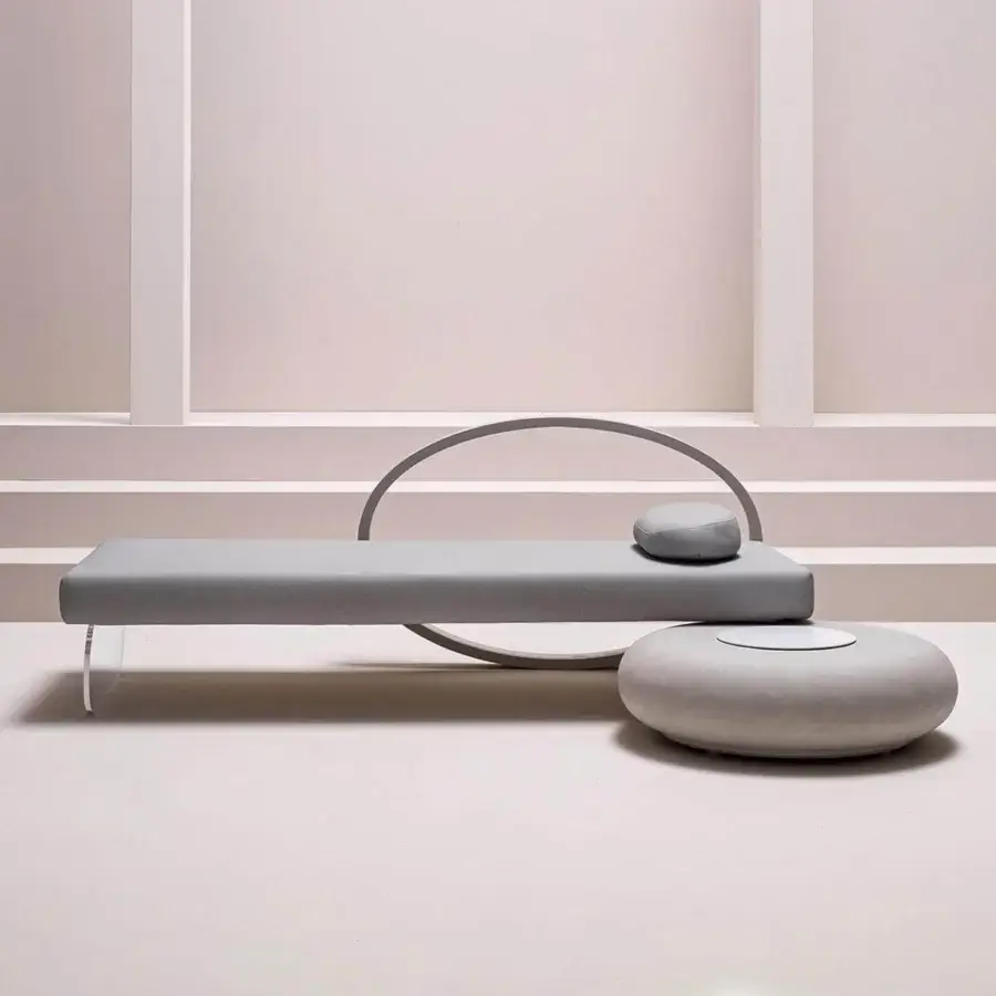 Innovative Varaschin Wellness Therapy bed with gray textile covering and curved metal headboard in a solid clear acrylic base