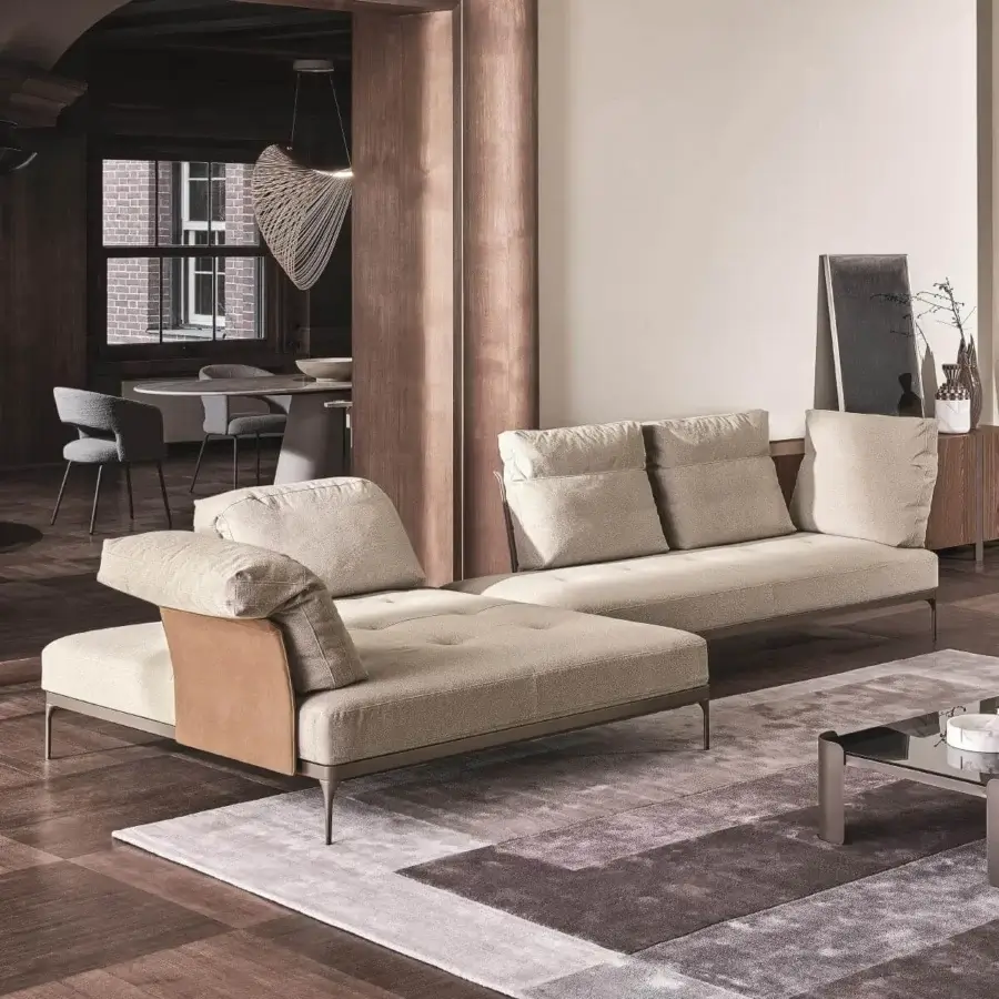 Distinguished Ditre Italia Ada sectional with a low profile and light beige textile upholstery accented with a leather-like panel and satin metal base