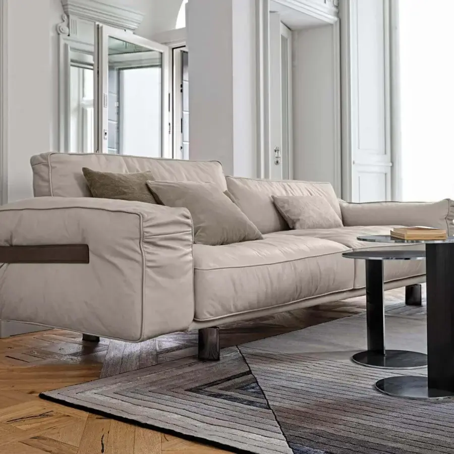 Lavish Arketipo Close to Me sofa with light beige textile upholstery and earth-toned leather wraparound belt crafted with metal clasps