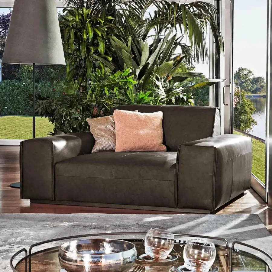 Sophisticated Ditre Italia Monolith lounge chair with dark brown textile and light brown peach cushions offers a harmonious design