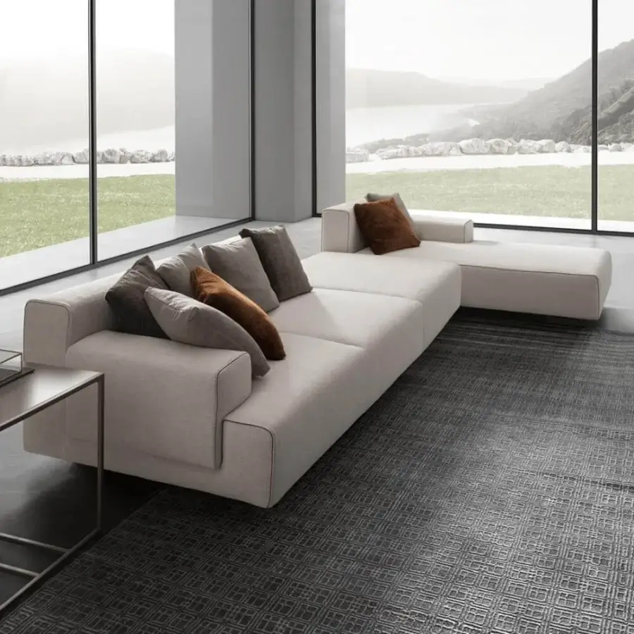 Stylish Presotto Leros sectional with light beige fabric, brown and grey pillows, plus peltro varnished metal feet