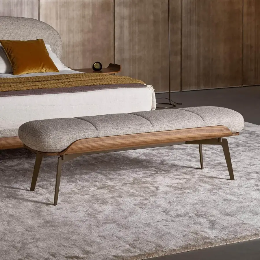 Sophisticated Bonaldo Olos bench with light gray padding and woven textile, complemented by curved Canaletto Walnut wood with matte bronze metal legs