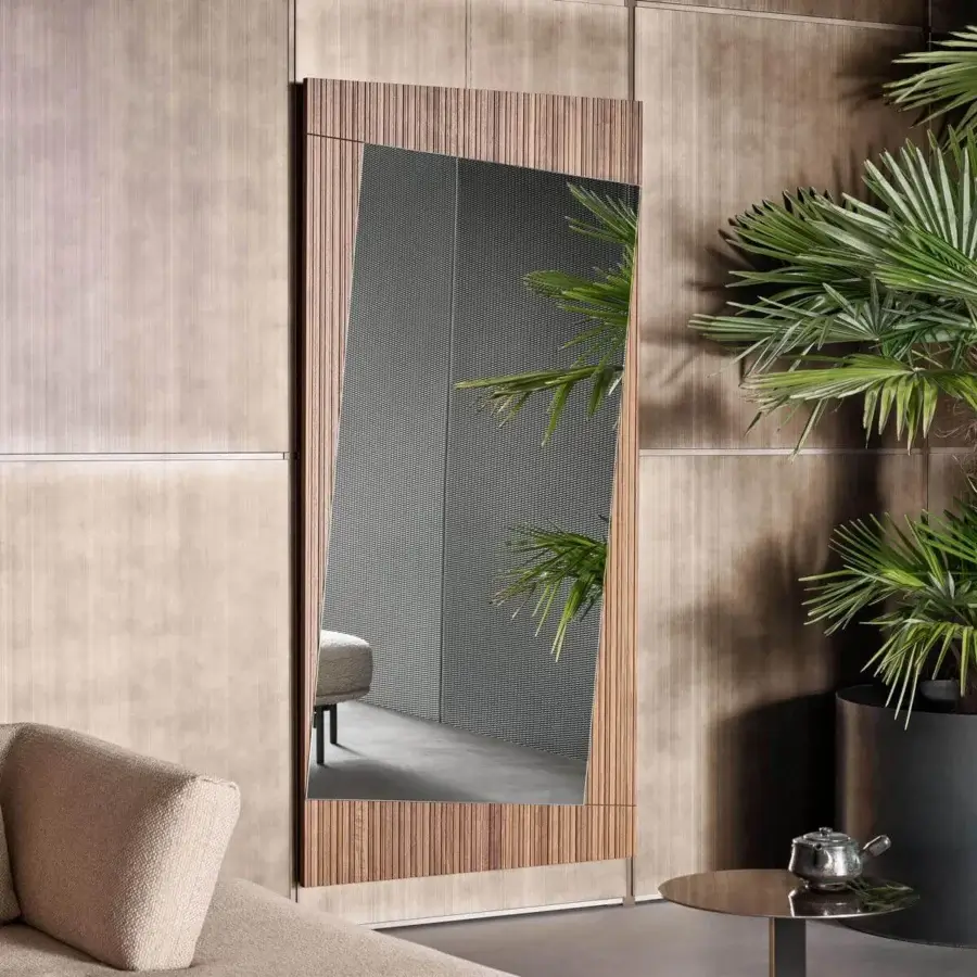 Distinguished Bonaldo Musa mirror with angled top in ribbed Canaletto Walnut wood showcasing reflective glass