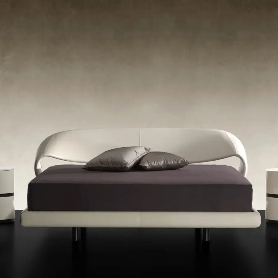 Distinctive Reflex Nuvola bed with curved headboard and side rails upholstered in light cream fabric with sleek matte black legs