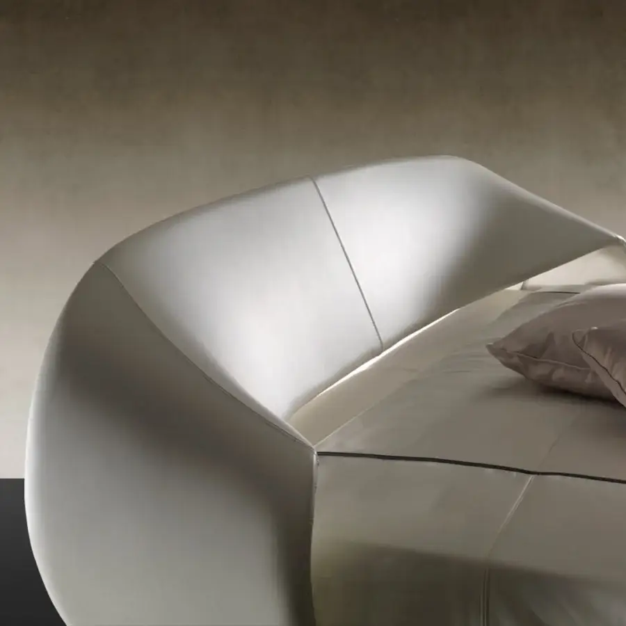 Captivating Reflex Nuvola bed with curved headboard and sides upholstered in smooth fabric or leather with sleek matt black legs