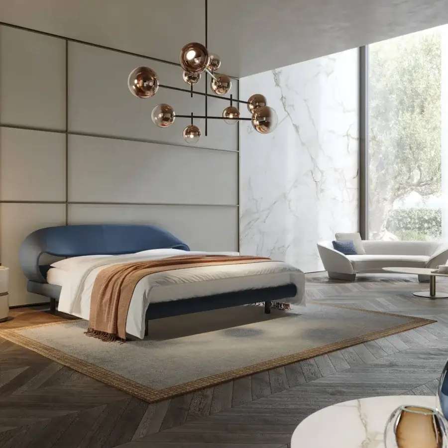 Distinguished Reflex Nuvola bed with curved headboard and sides upholstered in stylish blue textile with sleek matt black legs