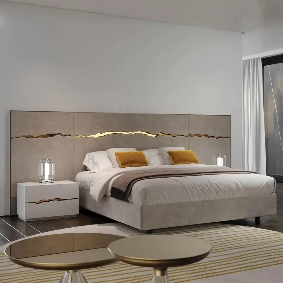 Neutral wall panel with a metallic line above a bed with light bedding and yellow pillows