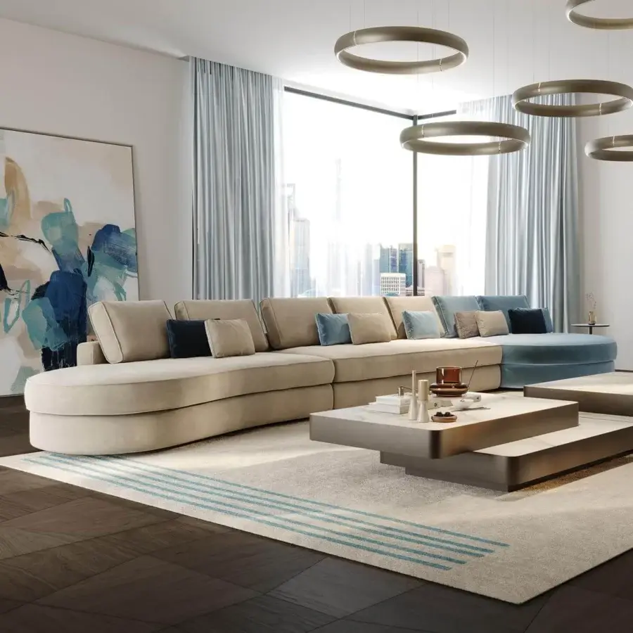 Sophisticated Reflex Adone sectional with rounded shapes upholstered in beige textile and goose feather cushions
