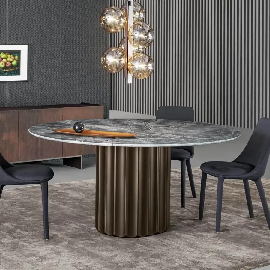 Architectural Bonaldo Dorian table with round marble top displaying gray and white veining and sculpted bronze-toned base