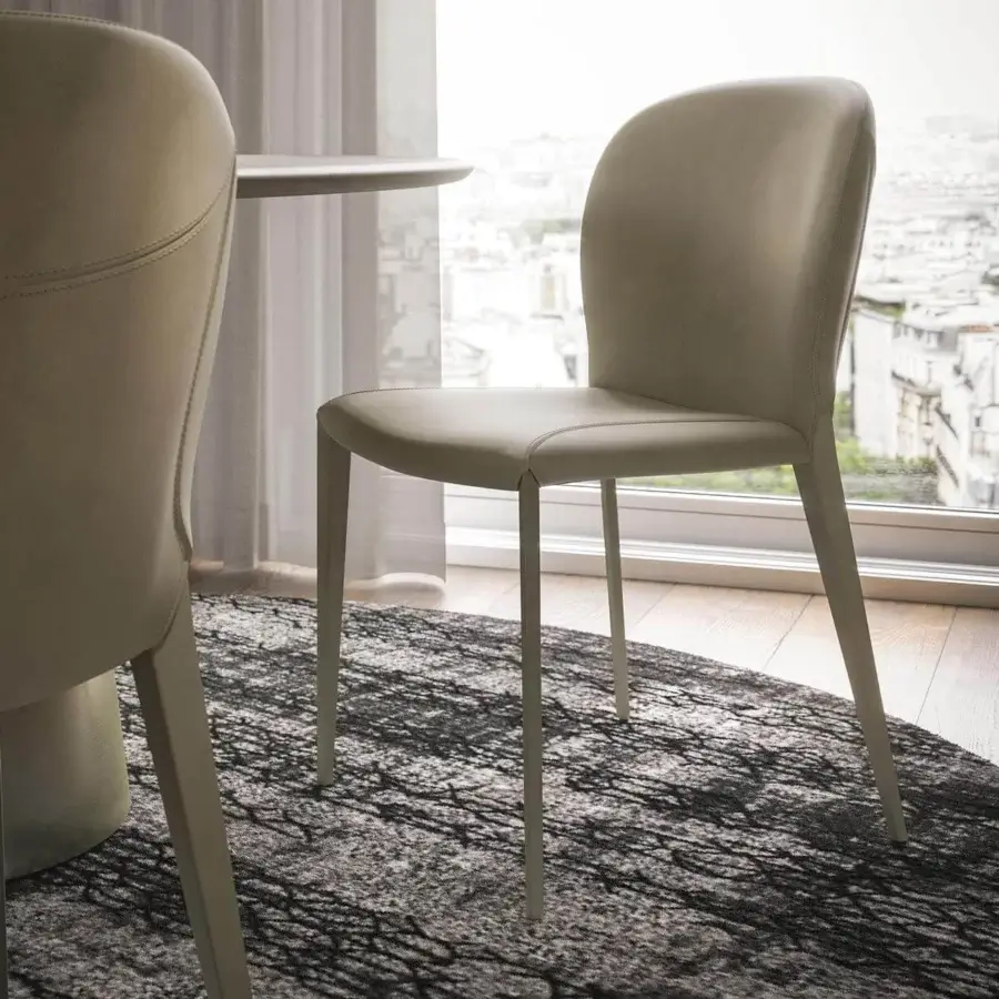 Elegant Cattelan Italia Nancy ML chair with light beige or grey upholstery and curved lines built with slender steel legs