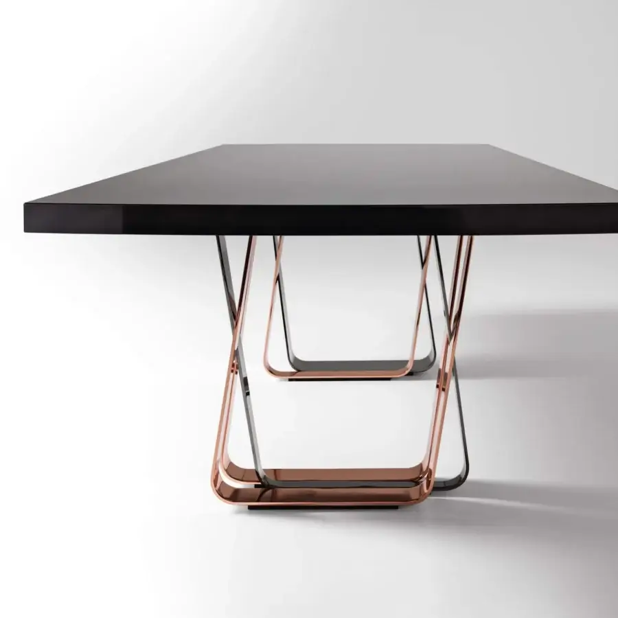 Superior Costantini Pietro Bend table with glossy black wood and angled metal parallelograms in copper and black finishes