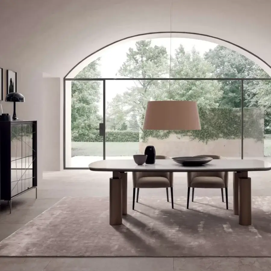 Elegant Presotto Kolosso table with an oval tabletop in light material and cylindrical legs crafted in a medium-toned wood-like finish