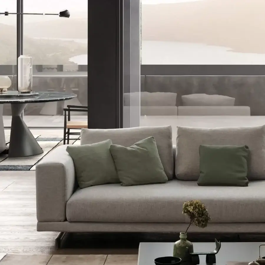 Distinguished Presotto San Marino sofa with light gray subtly textured textile and peltro varnished metal feet, accented with green cushions