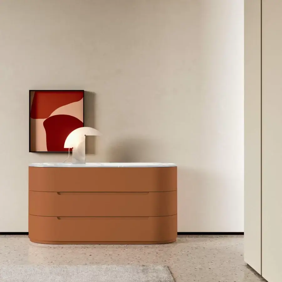 Elegant Presotto Globo dresser with curvilinear form in muted orange matte lacquer and light marble surface