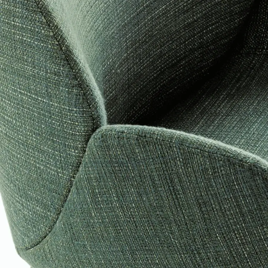 Superior Giorgetti Calathea armchair upholstered in textured deep teal fabric with a durable metal base and swivel function