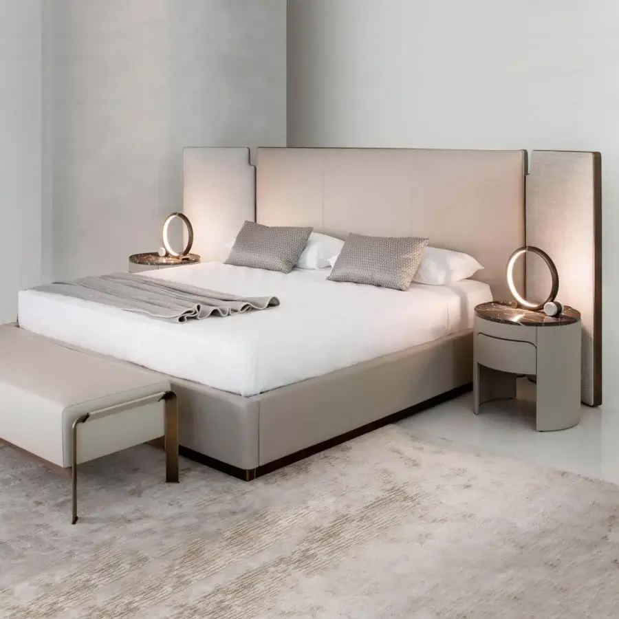 Elegant Rugiano Falcon bed with beige fabric or leather upholstery and recessed base creating a floating effect with bronze brass accents