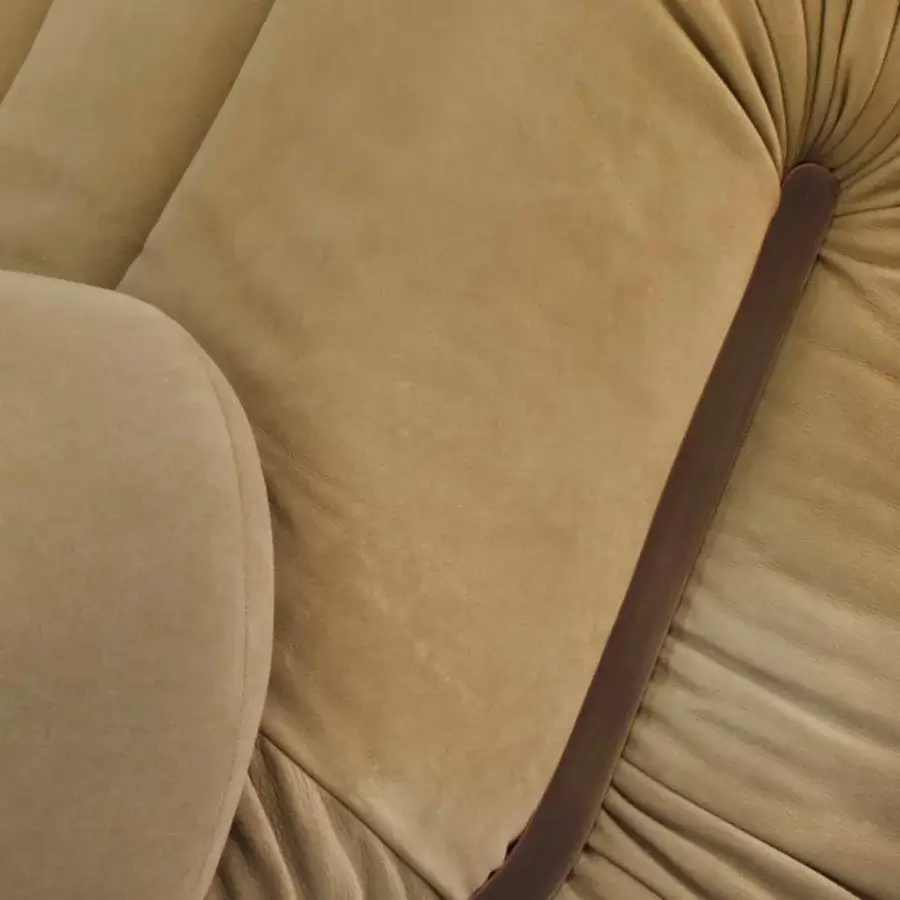 Lavish Rugiano Snake lounge chair with rounded form fully upholstered in light tan suede and dark brown trim