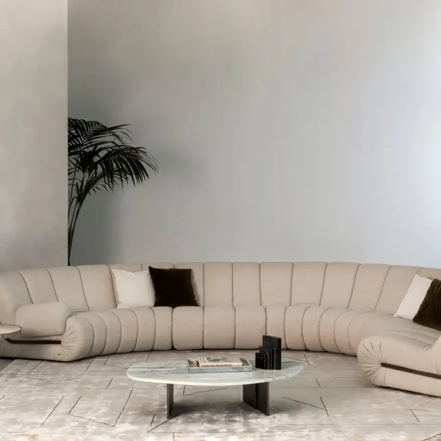 Distinguished Rugiano Snake sectional upholstered in light beige textured textile with dark brown trim and matte finish