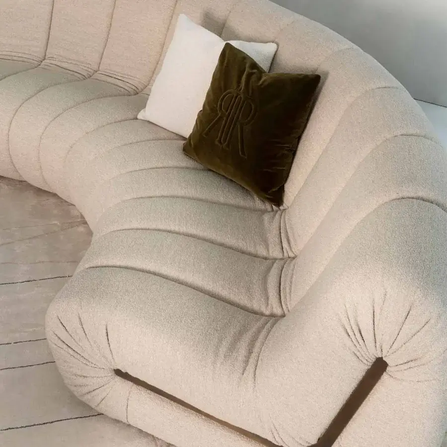 Captivating Rugiano Snake sectional upholstered in textured light beige textile with a dark accent element