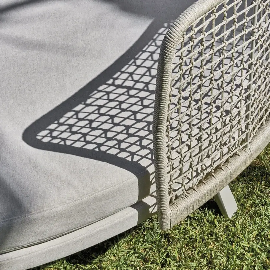 Superior Varaschin Emma daybed with a cocooning high backrest expertly handwoven in textured light neutral synthetic fiber