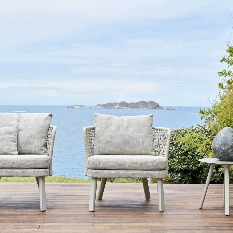 Distinguished Varaschin Emma lounge chair with woven light gray textile and painted light gray metal base