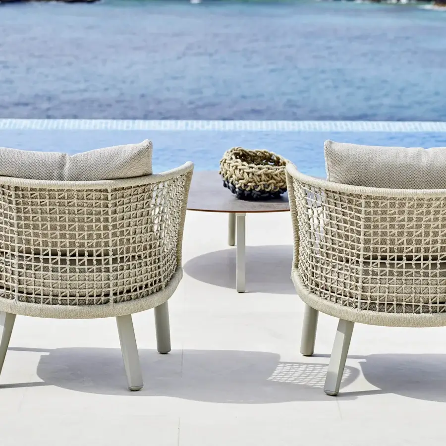 Sophisticated Varaschin Emma lounge chair crafted with interwoven beige ropes and a light-colored cushion for relaxing outdoor spaces