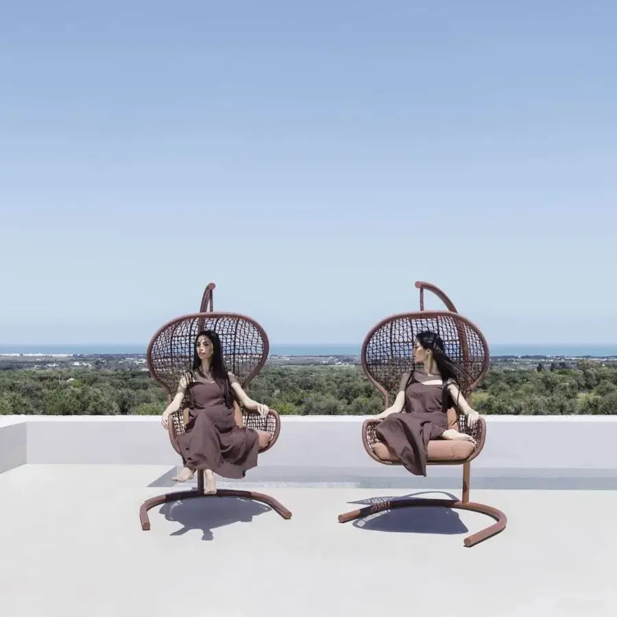 Sophisticated Varaschin Emma swing chair with matte brown metal framework and coordinating textile cushion
