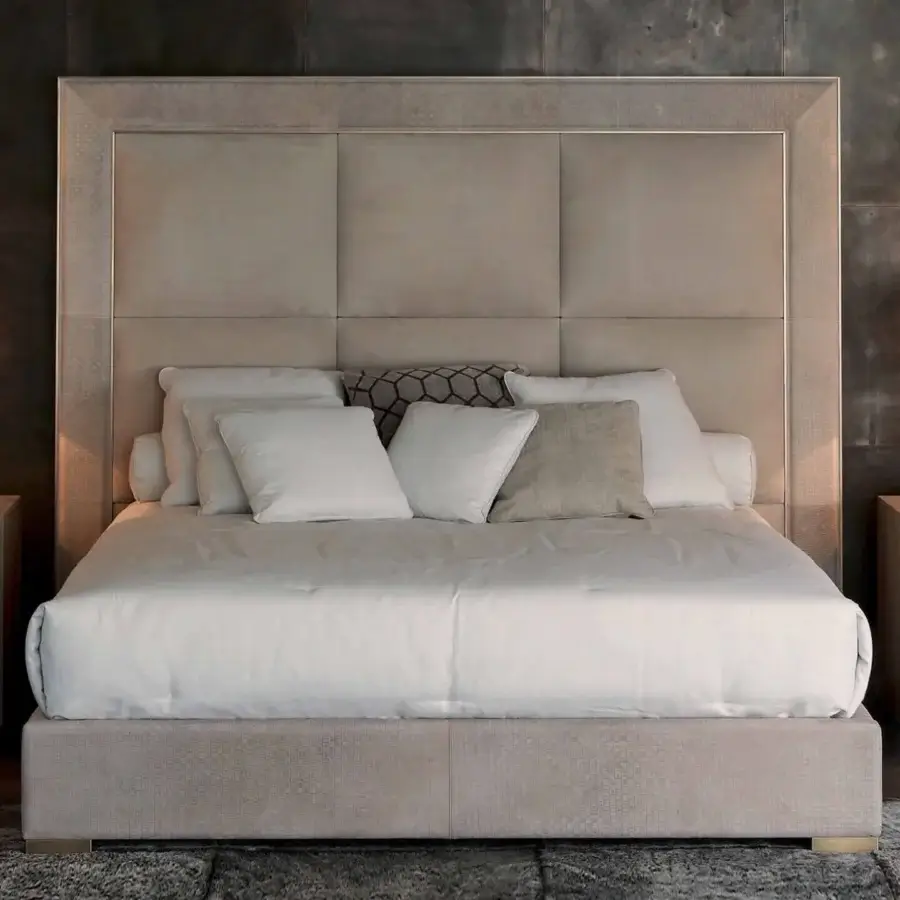 Distinguished Rugiano Aura bed upholstered in muted beige textured fabric with a decorative embroidered frame