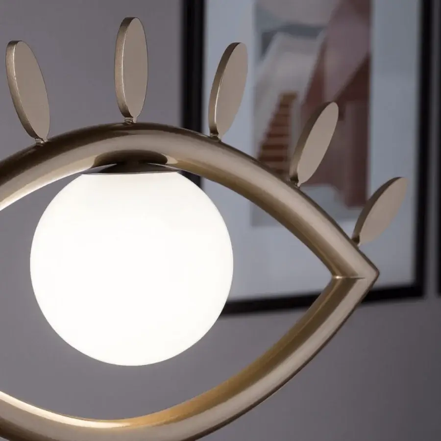 Exceptional Masiero Visio table lamp with a surreal eye-shaped design crafted in painted metal and Murano triplex glass with a muted gold finish