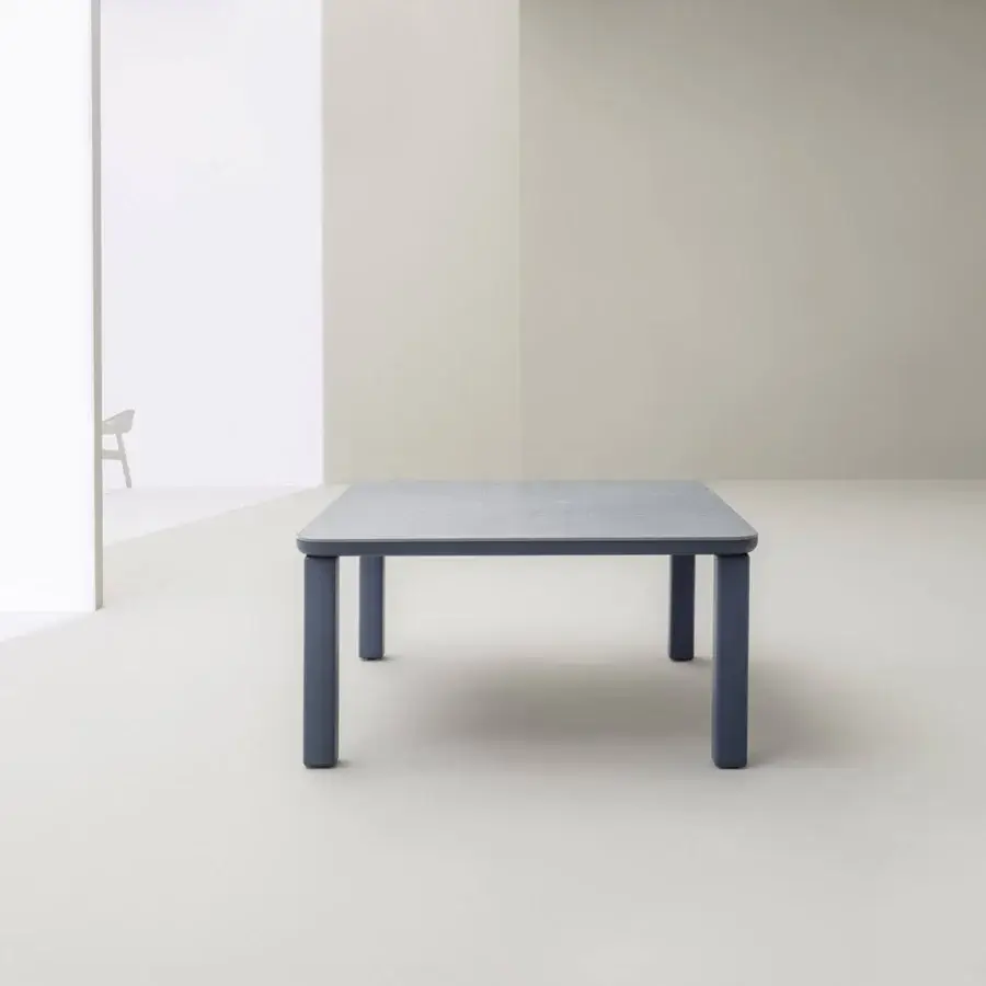 Distinguished Varaschin Customade table with a muted gray-blue HPL tabletop and cylindrical legs in a matte finish