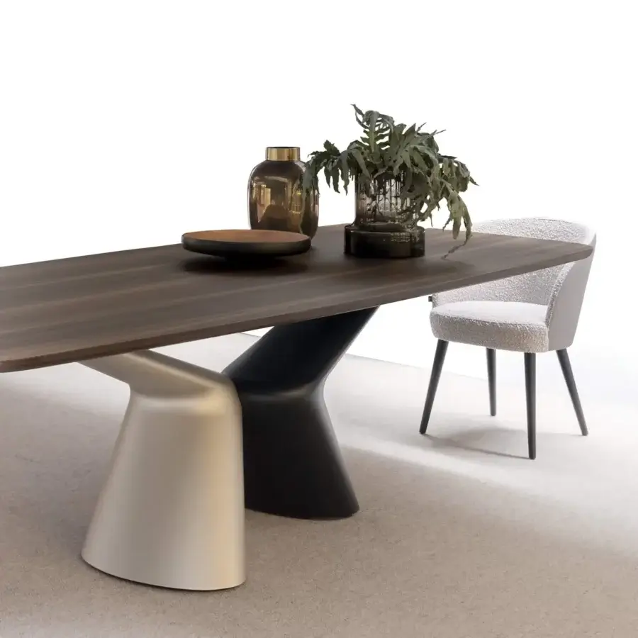 Elegant Presotto Victor table with a dark rounded tabletop and sculptural pedestal legs in contrasting finishes