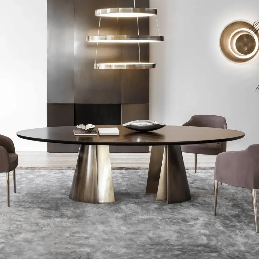 Elegant Rugiano Absolute table with dark wood-like top and light metallic textured pedestal legs