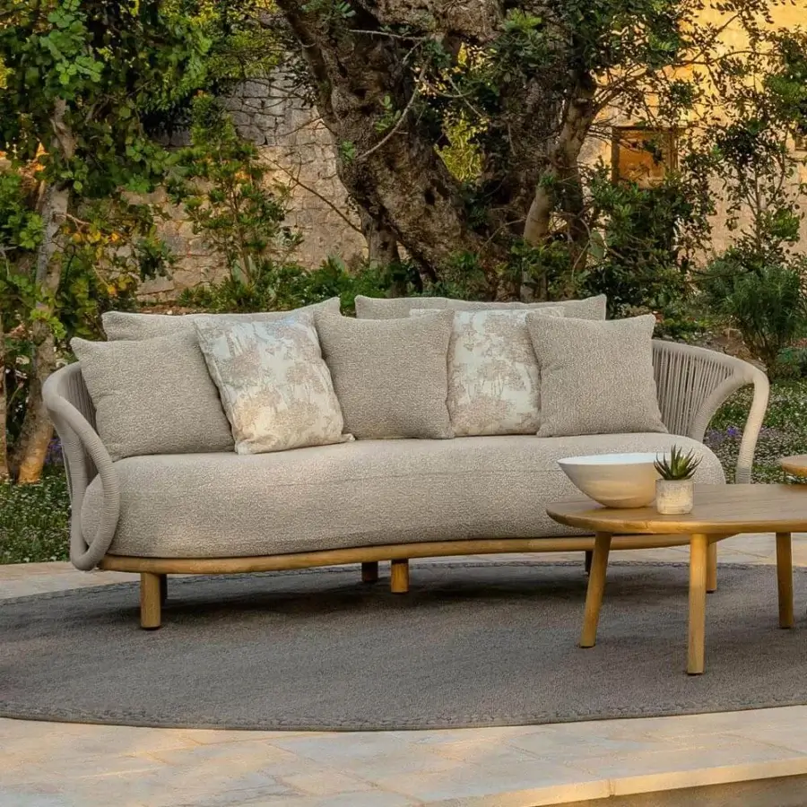 Stylish Talenti Karen sofa embodies a tribal aesthetic with enveloping shapes and curved lines in light beige textured textile with integrated rope armrests
