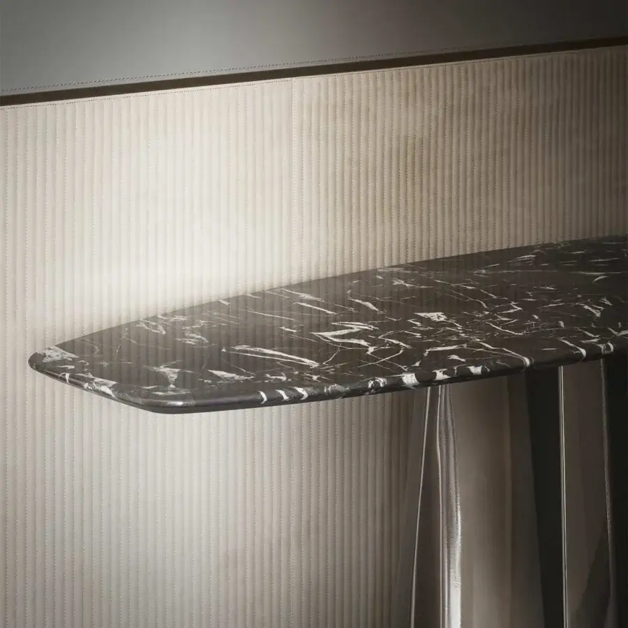 Elegant Rugiano Absolute console with black marble top exhibiting delicate white veining and unique metal structure