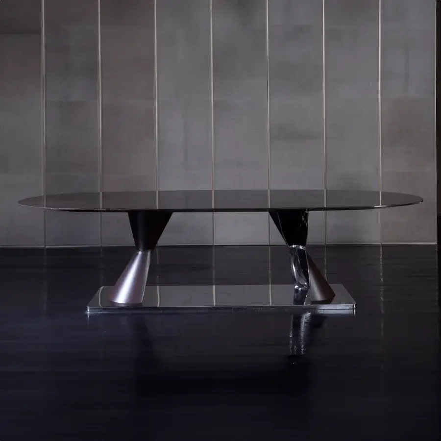 Distinguished Rugiano Rea table crafted with an ebony finish and mirrored bronzed brass pedestal bases