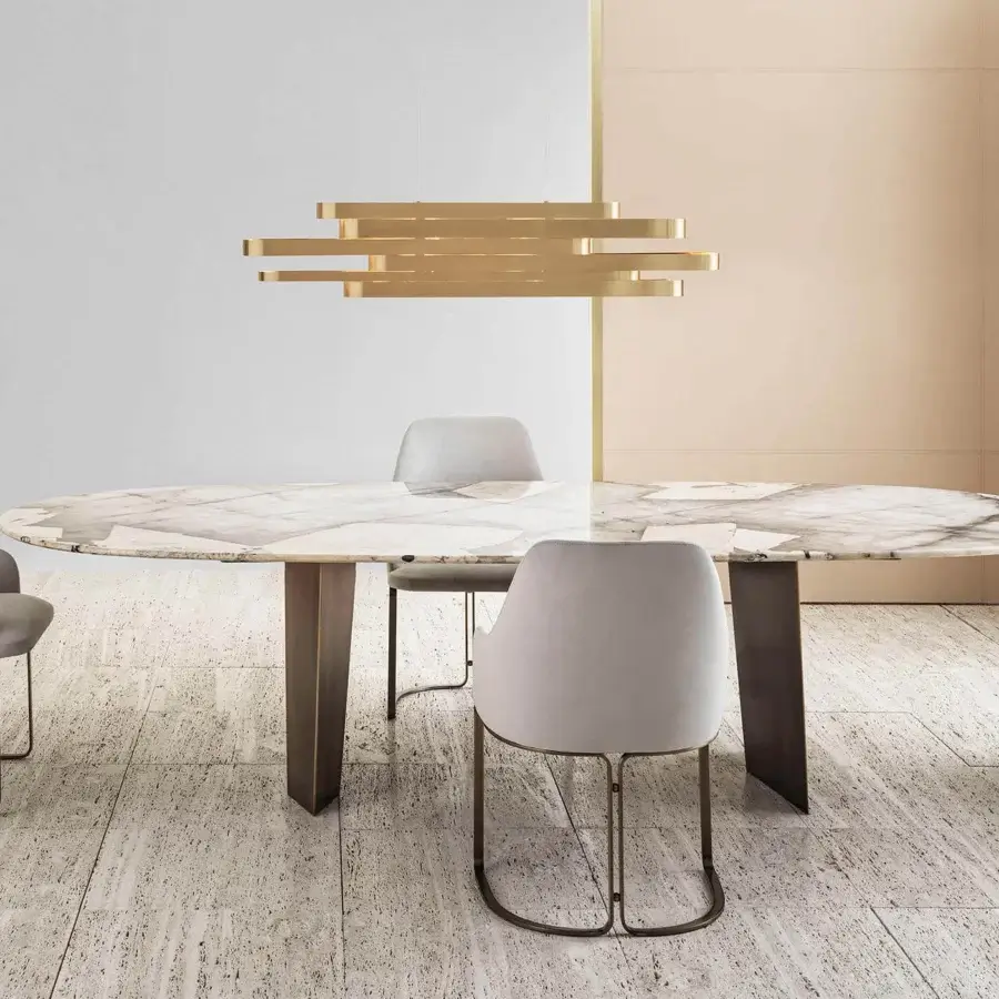 Distinguished Rugiano Pedro table with oval marble exhibiting white, gray and brown tones plus bronzed brass legs