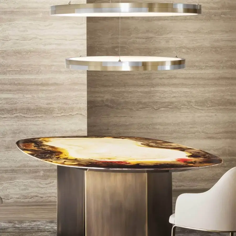 Lavish Rugiano Pedro table with glossy oval tabletop exhibiting brown, yellow, and red tones crafted with matte bronzed brass base